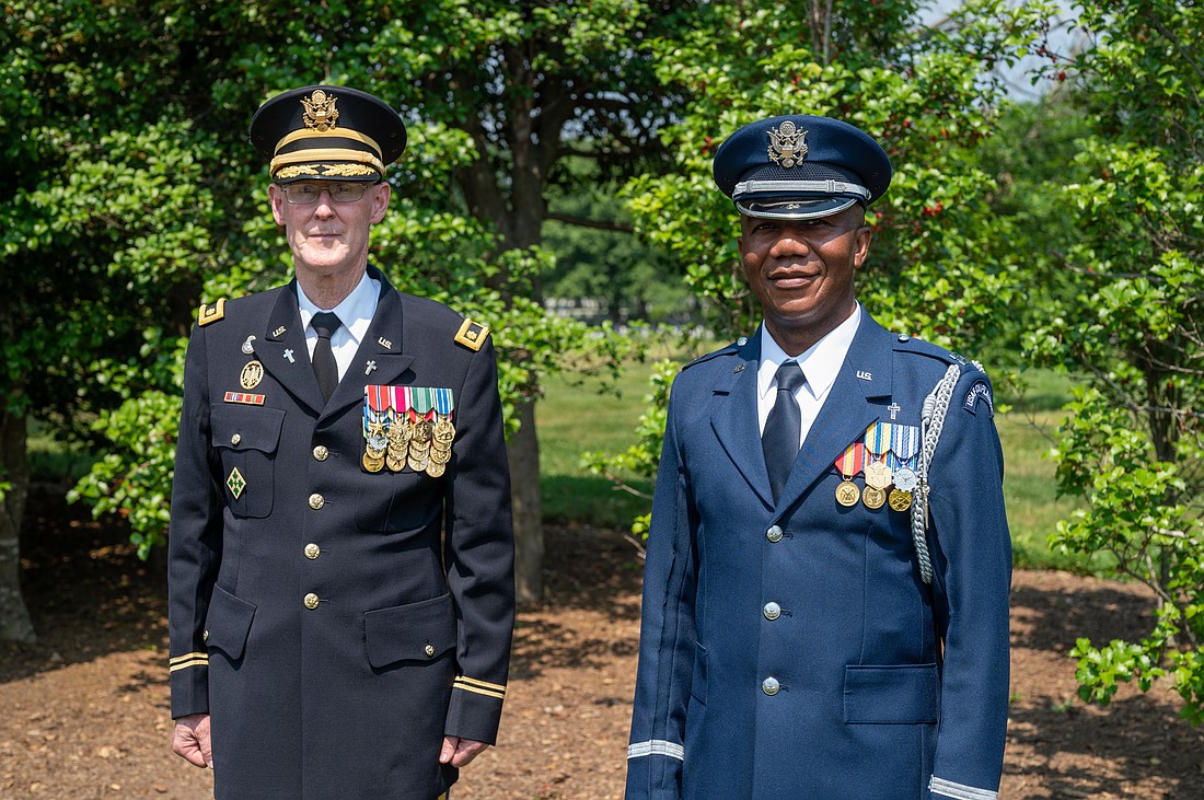 Father David Kirk, an Army chaplain who holds the rank of major, and Father Nelson Ogwuegbu, an Air Force chaplain who holds the rank of captain, pose for a photo May 26, 2021, at Arlington National Cemetery in Virginia. (OSV News photo/Matt Riedl, Arlington Catholic Herald)