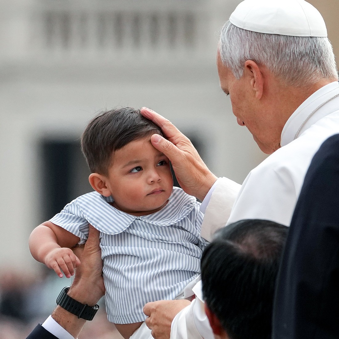 Pope Leo XIV greets a child from the popemobile as he rides around St. Peter's Square at the Vatican before his weekly general audience Oct. 22, 2025. (CNS photo/Lola Gomez)