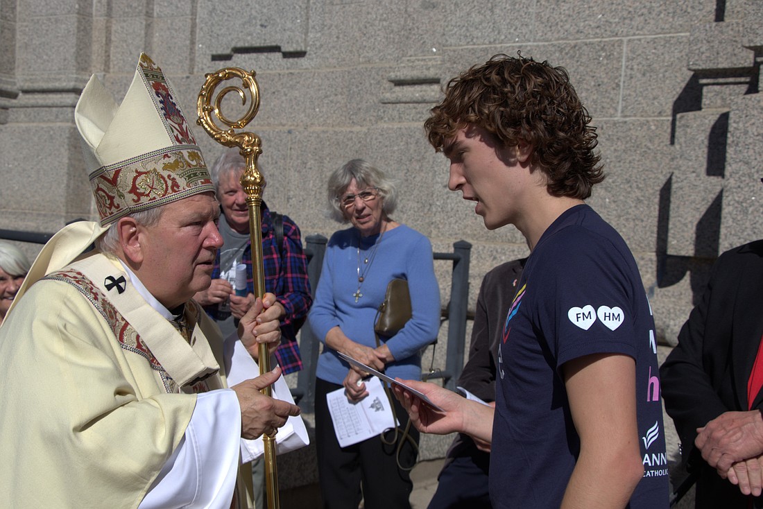 Archbishop Bernard A. Hebda of St. Paul and Minneapolis accepts a letter Jimmy Kaiser wrote to Pope Leo XIV thanking the pontiff for his prayers for the Annunciation community in Minneapolis, including the Kaiser family. Archbishop Hebda delivered that letter -- and other letters from students and families at Annunciation -- to Pope Leo Oct. 1, 2025, at the Vatican. (OSV News photo/Tom Halden, courtesy Archdiocese of St. Paul and Minneapolis)