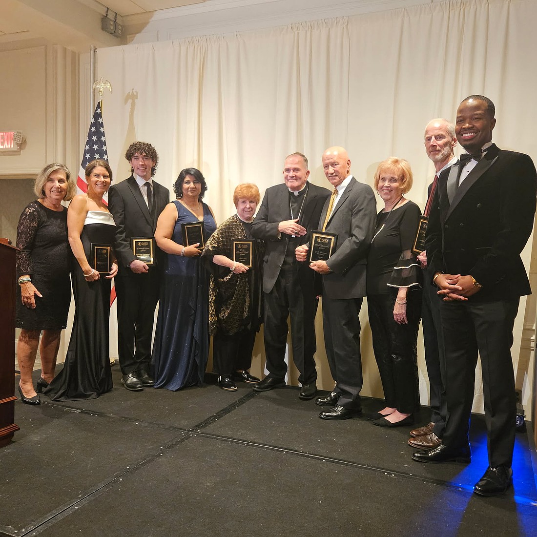 Jane Chrnelich, chair of Mount Carmel Guild's board of trustees, left; Bishop David M. O'Connell, C.M., center, and Daren Miller, executive director, pose for a photo with the 2025 honorees during the annual gala held Oct. 24 in Trenton Country Club.
