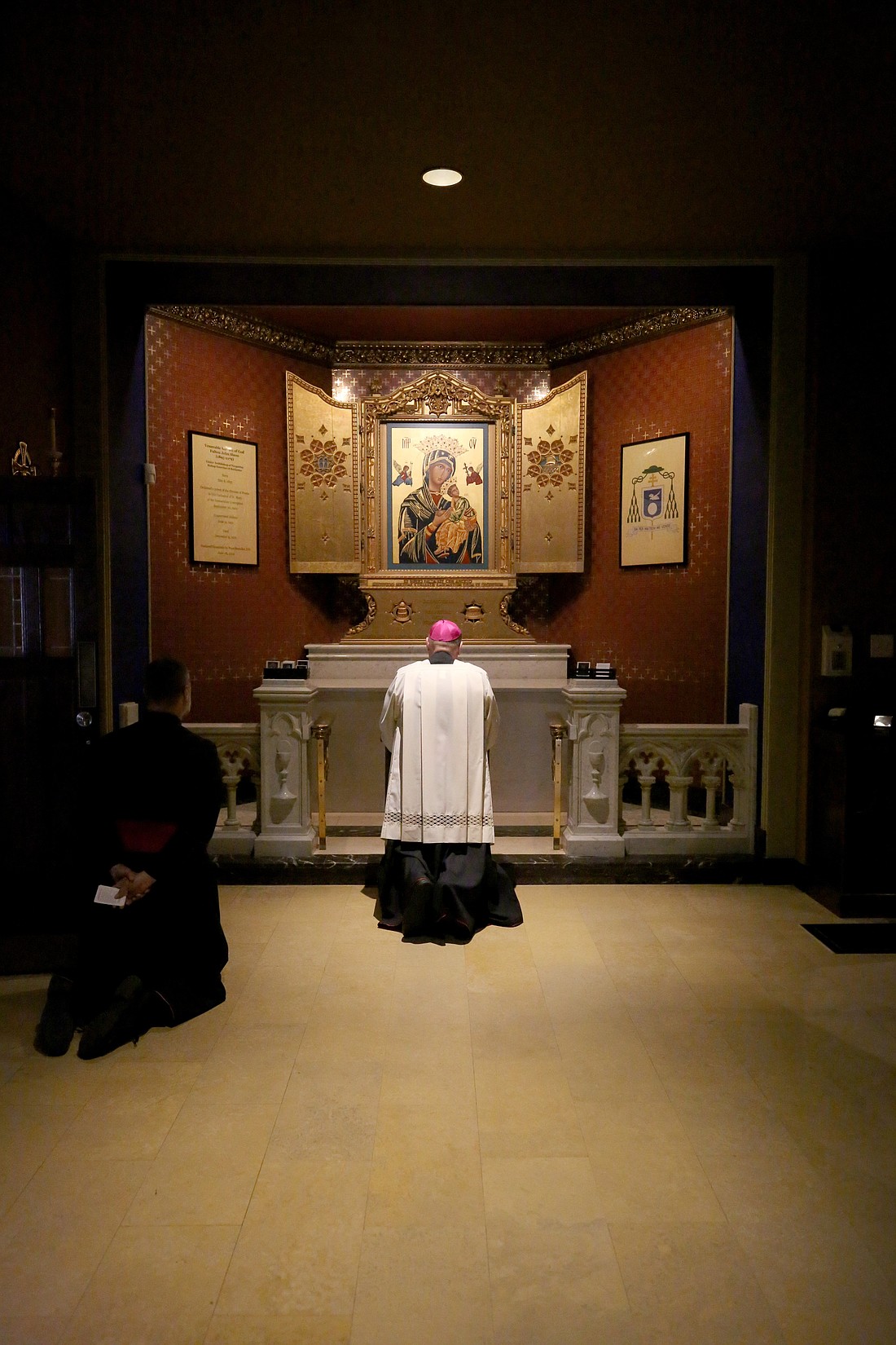 Msgr. Jason Gray, executive director of the Archbishop Fulton John Sheen Foundation in Peoria, Ill., and Bishop Louis Tylka of Peoria pray at the tomb of Venerable Archbishop Fulton Sheen at the Cathedral of St. Mary in Peoria Oct. 19, 2025, before a groundbreaking ceremony outside the historic Spalding Institute to convert Archbishop Sheen's alma mater into a cultural center. (OSV News photo/courtesy of Nellie Photography)