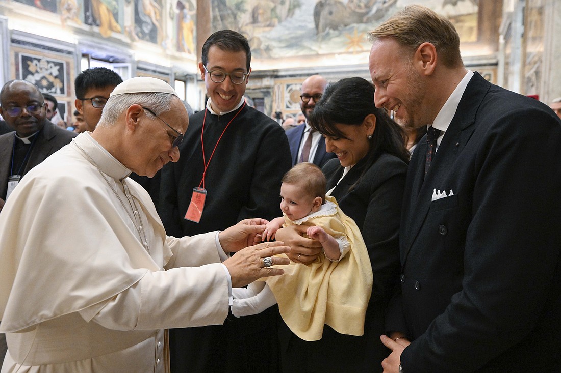 Pope Leo XIV greets a baby at the end of an audience with faculty, staff, students and alumni of the John Paul II Pontifical Theological Institute for Marriage and Family Sciences at the Vatican Oct. 24, 2025. (CNS photo/Vatican Media)