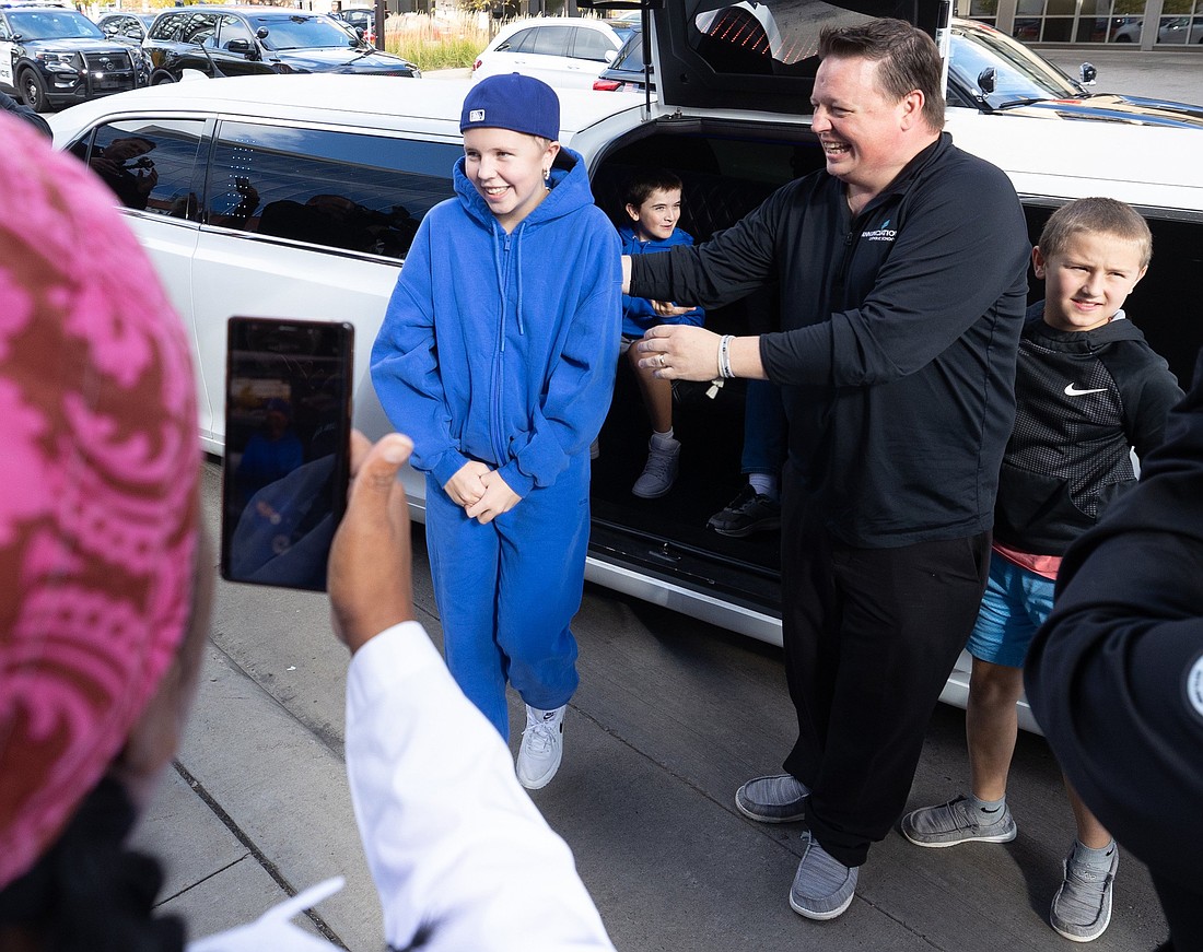 Sophia Forchas, who survived a gunshot wound to the head during an all-school Mass at Annunciation Church in Minneapolis Aug. 27, 2025, and her father, Tom Forchas, exit a limousine at Hennepin County Medical Center in downtown Minneapolis Oct. 23, just after her release from Gillette Children's Hospital in St. Paul. A police escort led by Minneapolis Police Chief Brian O’Hara arrived at HCMC for a brief visit with hospital staff there who treated Sophia. (OSV News photo/Dave Hrbacek, The Catholic Spirit)