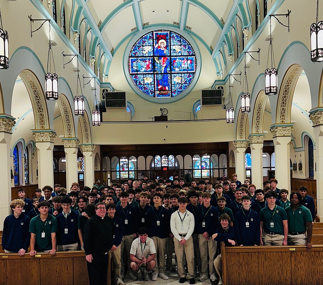 Red Bank Catholic High School students gather in St. James Church, Red Bank, for their meeting with Father Christopher Colavito, shown left. Staff photo
