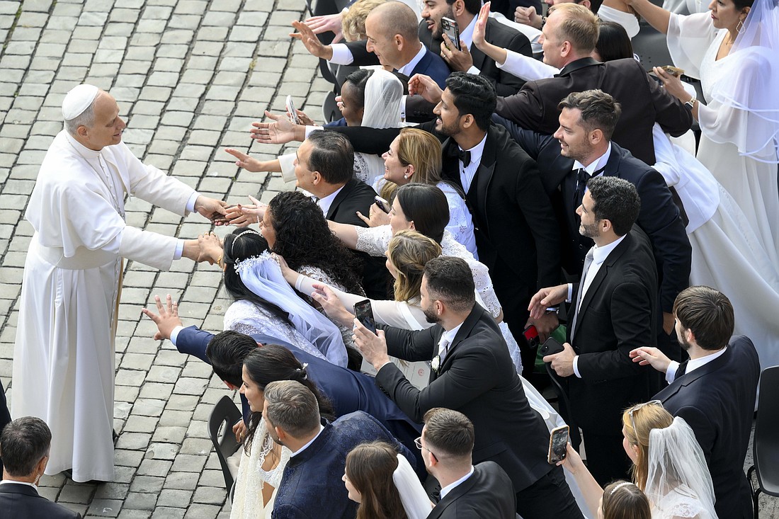 Pope Leo XIV greets newlywed couples before the start of his weekly general audience in St. Peter's Square at the Vatican, Oct. 29, 2025. (CNS photo/Vatican Media)