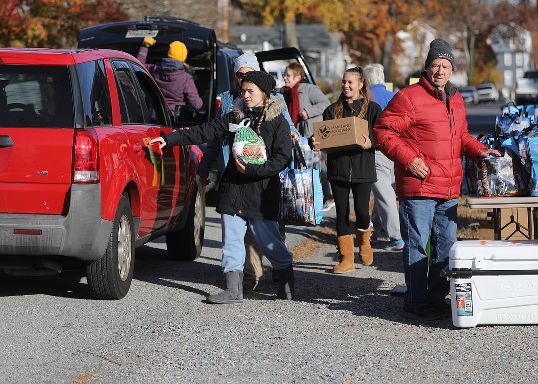 Volunteers with the Ladies of Charity of Calvert County, Md., load turkeys and other provisions into the car of a person in need at a food pantry in North Beach Nov. 20, 2021. With funding for SNAP scheduled to lapse Nov. 1, 2025, due to the federal government shutdown, Catholic outreach leaders are warning that the increased need could stretch many hunger relief ministries, and those they serve, to the limit. (CNS photo/Bob Roller)