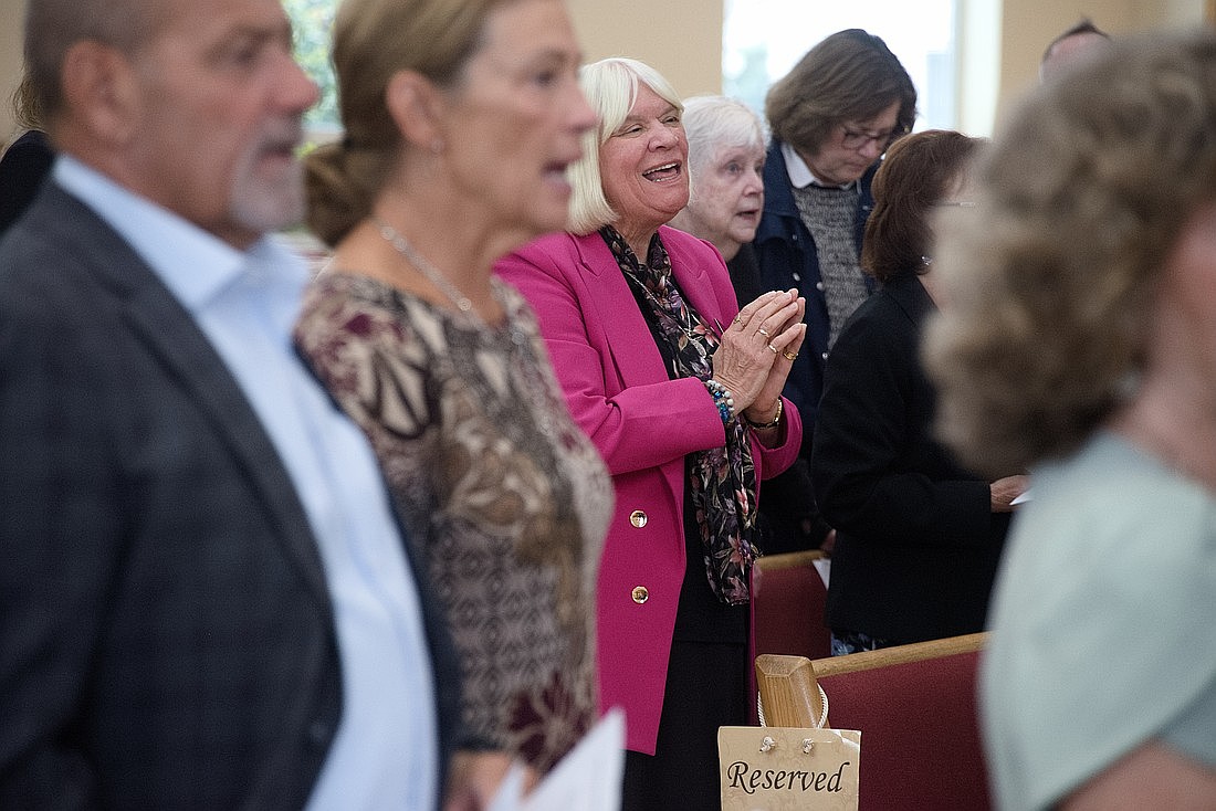Members of the Marian Servants of the Holy Family join in joyful prayer during a special Mass at St. Gregory the Great Parish in Hamilton Square on Oct. 11. Joe Moore photo