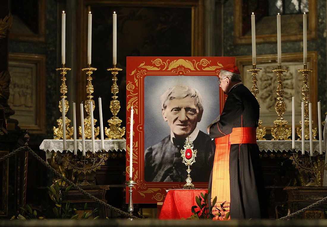 Cardinal Stanislaw Rylko, archpriest of the Basilica of St. Mary Major, walks past an image of St. John Henry Newman during vigil in advance of his canonization, at the Basilica of St. Mary Major in Rome Oct. 12, 2019. (CNS photo/Paul Haring)
