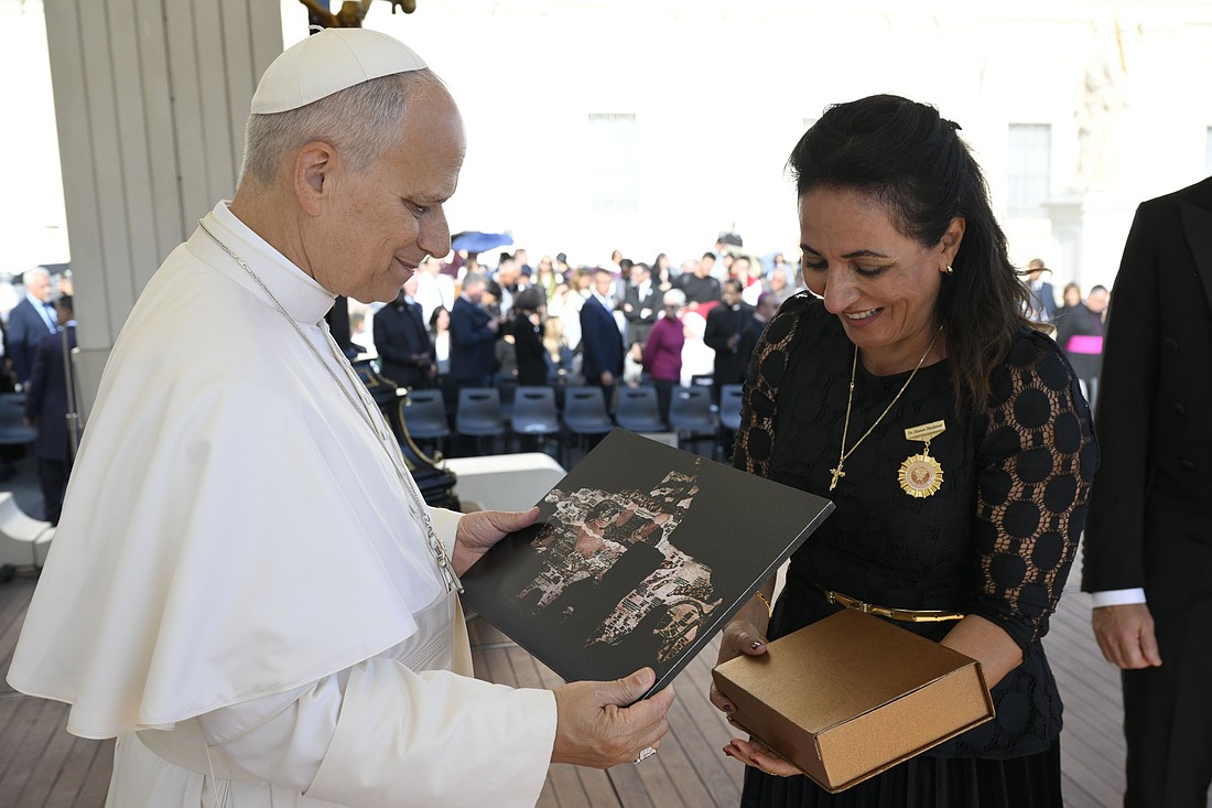 Pope Leo XIV receives a gift from Hanan Madanat, dean of the faculty of languages and communication at American University of Madaba in Jordan, during an audience in St. Peter's Square at the Vatican Oct. 31, 2025, for the Jubilee of the World of Education. (CNS photo/Vatican Media)
