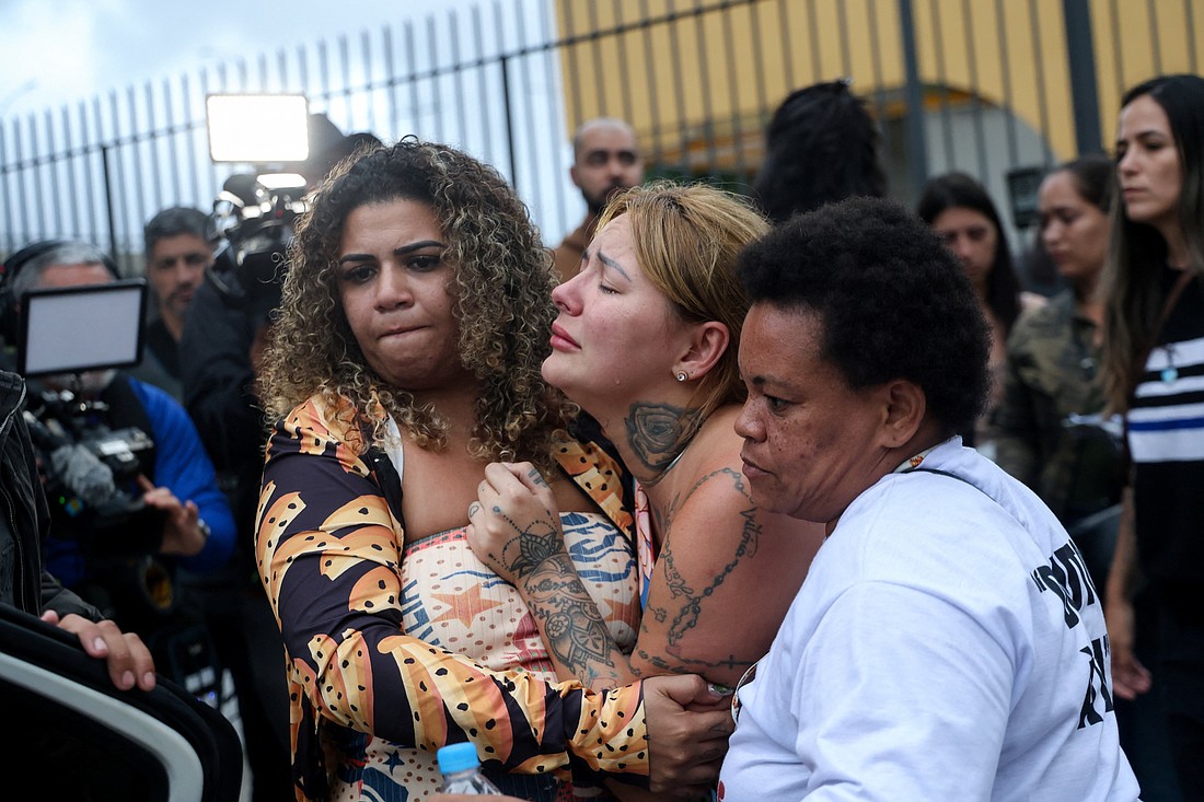 A woman reacts as people gather outside a morgue while family members wait to identify bodies after a deadly police operation against drug trafficking in the favela do Penha in Rio de Janeiro Oct. 30, 2025. (OSV News photo/Aline Massuca, Reuters)