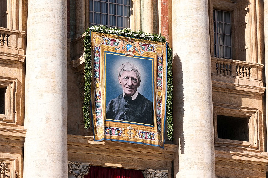 A tapestry of St. John Henry Newman hangs from the facade of St. Peter’s Basilica at the Vatican Nov. 1, 2025, during the Mass in which Pope Leo XIV declared the 19th-century English cardinal and theologian a doctor of the church. The liturgy concluded the Jubilee of the World of Education. (CNS photo/Lola Gomez)