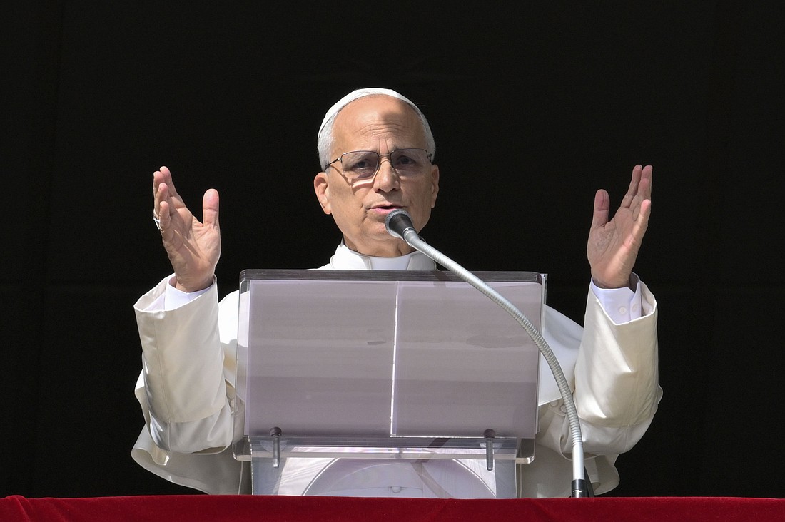 Pope Leo XIV, from the window of his studio in the Apostolic Palace, prepares to give his blessing to people gathered in St. Peter's Square at the Vatican to recite the Angelus prayer on the feast of All Souls, Nov. 2, 2025. (CNS photo/Vatican Media)