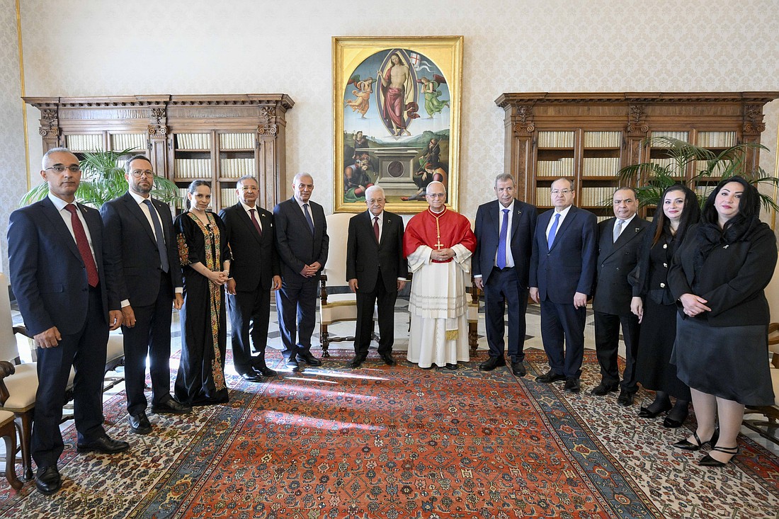 Pope Leo XIV and Palestinian President Mahmoud Abbas pose for a photo with Abbas' delegation during a meeting in the library of the Apostolic Palace at the Vatican Nov. 6, 2025. (CNS photo/Vatican Media)