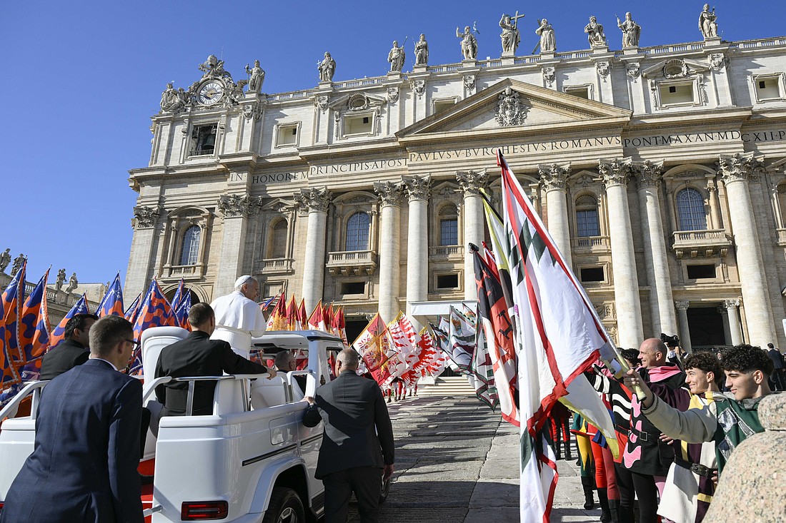 As Pope Leo XIV makes his way in the popemobile to the stage in St. Peter's Square at the Vatican Nov. 8, 2025, members of Italian folklore groups line a path for him. (CNS photo/Vatican Media)