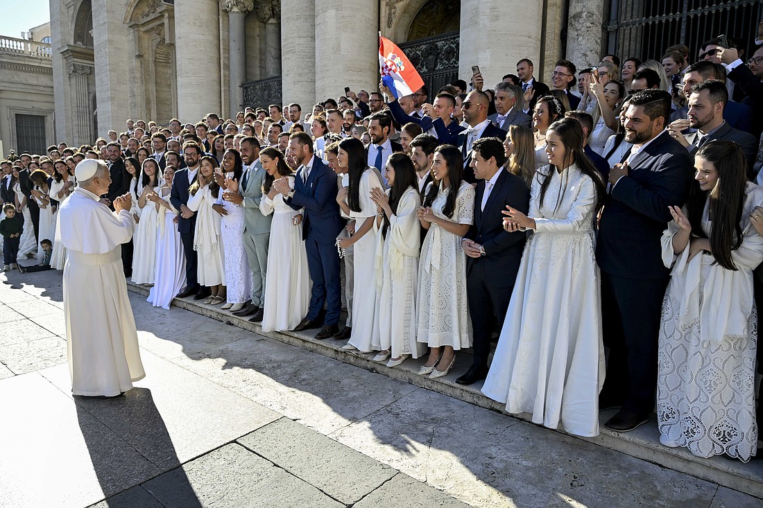 Pope Leo XIV greets dozens of newlywed couples who came to St. Peter's Square at the Vatican for his blessing after his general audience Nov. 12, 2025. (CNS photo/Vatican Media)