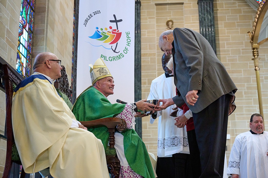 Bishop O’Connell accepts the Offertory gifts from Patricia & Samuel Falconella of Our Lady of Sorrows-St. Anthony Parish, Hamilton, during the Oct. 5 Mass in St. Mary of the Assumption Cathedral, Trenton. The Falconellas are married 63 years. Mike Ehrmann photo