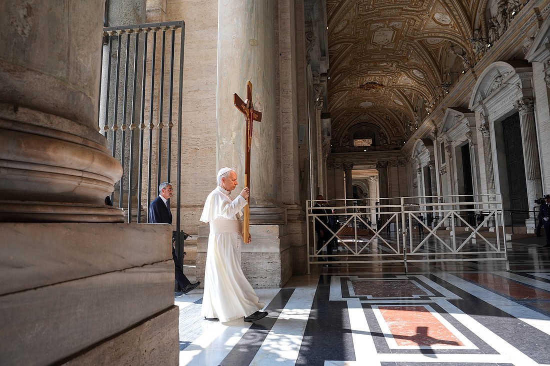 Carrying the Jubilee cross, Pope Leo XIV leads a procession including members of the Roman Curia toward the Holy Door of St. Peter's Basilica during the Jubilee of the Holy See at the Vatican June 9, 2025. (CNS photo/Lola Gomez)
