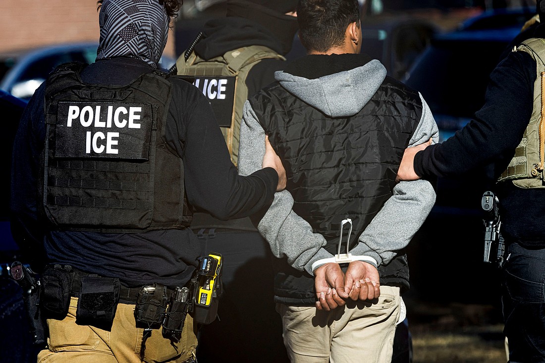 Agents with the Immigration and Customs Enforcement detain a man after conducting a raid at the Cedar Run apartment complex in Denver Feb. 5, 2025. (OSV News photo/Kevin Mohatt, Reuters)