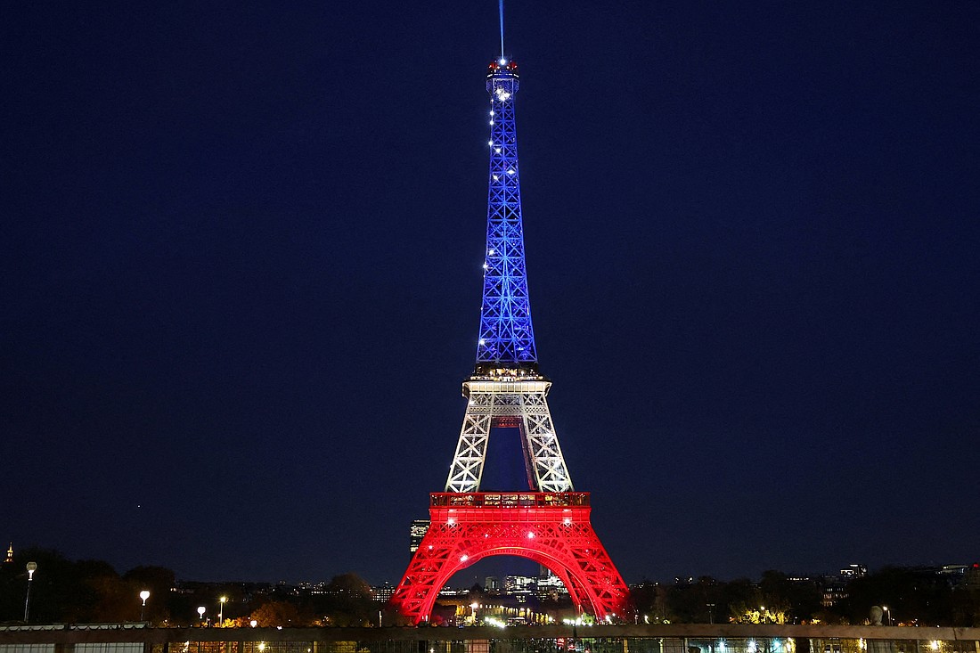 The Eiffel Tower is lit up with the blue, white and red colors of the French flag in Paris Nov. 12, 2025, to mark the tenth anniversary of the Nov. 13, 2015, attacks. (OSV News photo/Abdul Saboor, Reuters)