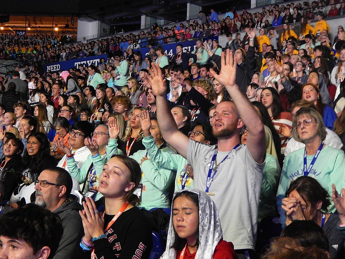 A participant prays during the closing Mass of the National Catholic Youth Conference at Lucas Oil Stadium in Indianapolis Nov 18, 2023. OSV News photo/Mike Krokos, The Criterion