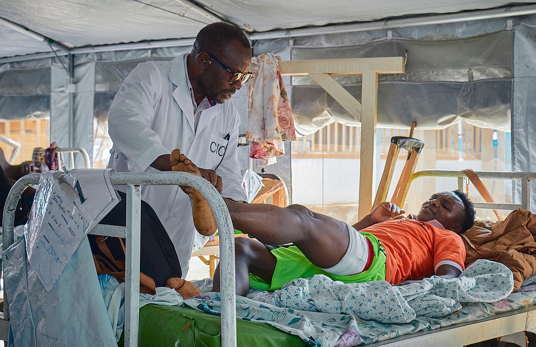 Samson Muhindo Kalumbi from the International Committee of the Red Cross attends to Jean-Baptiste Kambale Viriko, 27, at  Beni General Hospital in Beni, in the North Kivu province of Congo, Oct. 2, 2025. Viriko was shot in the thigh while caught up in fighting between M23 combatants and a local militia. On Nov. 14, in the same province, members of the Allied Democratic Forces, a group loyal to Islamic State, attacked a clinic run by the Presentation Sisters, killing 15 people before stealing medications and burning the clinic down. (OSV News/Gradel Muyisa Mumbere, Reuters)