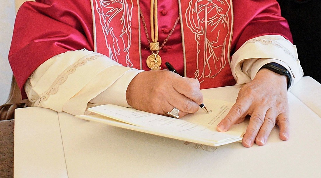 Pope Leo XIV signs a document in this file photo from Oct. 4, 2025. The pope released an apostolic letter, "In Unitate Fidei" ("In the Unity of Faith") Nov. 23, 2025, looking at the Creed on the 1,700th anniversary of the Council of Nicaea. (CNS photo/Vatican Media)