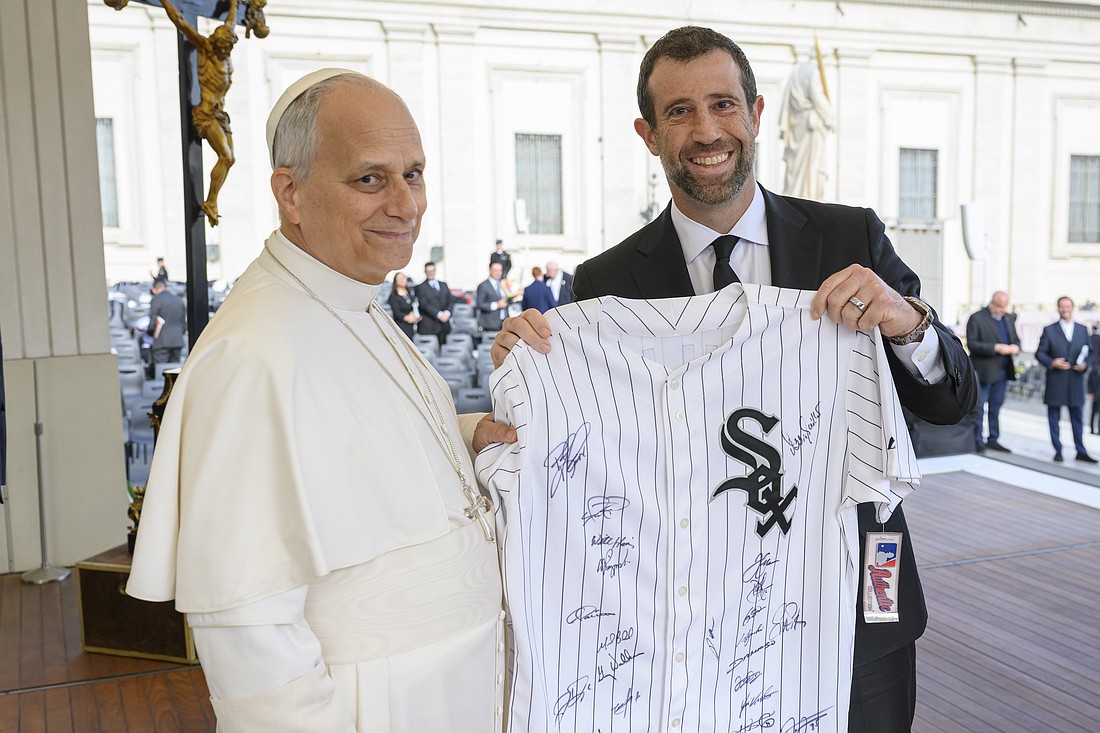 Pope Leo XIV poses for a photo with Justin Ishbia, a co-owner of the Chicago White Sox, after receiving a team jersey at the end of the pope's weekly general audience Nov. 19, 2025, in St. Peter's Square at the Vatican. (CNS photo/Vatican Media) EDITORS: For news use only.