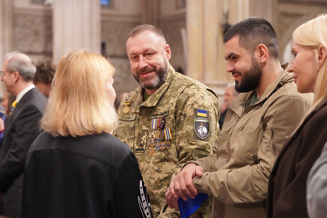 Ukrainian soldiers speak with participants during a Nov. 22, 2025, prayer service at St. Patrick's Cathedral in New York commemorating millions of Ukrainians killed in the Holodomor, an artificial famine engineered by Soviet dictator Joseph Stalin in 1932-1933. Speakers at the annual prayer service drew chilling parallels between Stalin’s campaign and current Russian attacks on Ukraine, which are approaching the 12-year mark, and which like the Holodomor have acutely impacted children in particular. (OSV News photo/Archeparchy of Philadelphia)