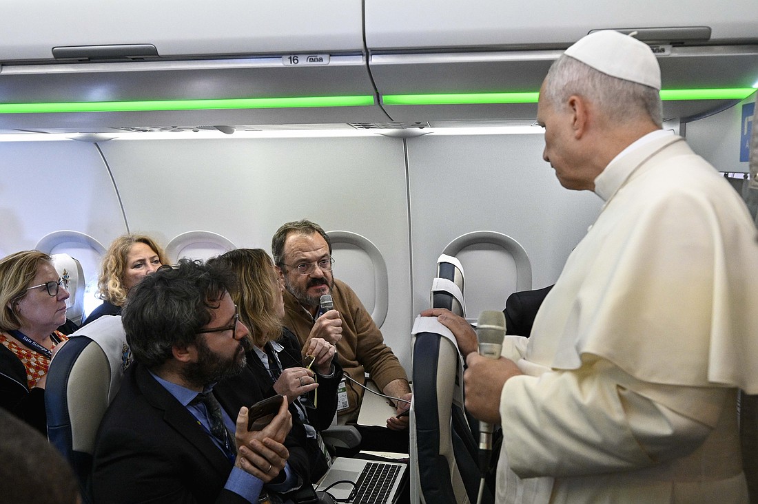 Pope Leo XIV listens to a question posed by Gian Guido Vecchi, a reporter for the Italian newspaper Corriere della Sera, during his flight from Lebanon to Rome Dec. 2, 2025. (CNS photo/Vatican Media)