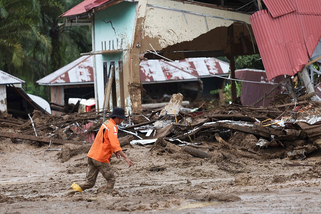 A rescuer walks through the mud Dec. 2, 2025, as the search and rescue operation continues in the town of Palembayan in Indonesia's West Sumatra province, an area hit by deadly flash floods following heavy rains. Rescue teams raced Dec. 3 to reach communities isolated by catastrophic floods and landslides in Indonesia, Sri Lanka and Thailand as over 800 people remained missing. (OSV News photo/Willy Kurniawan, Reuters)