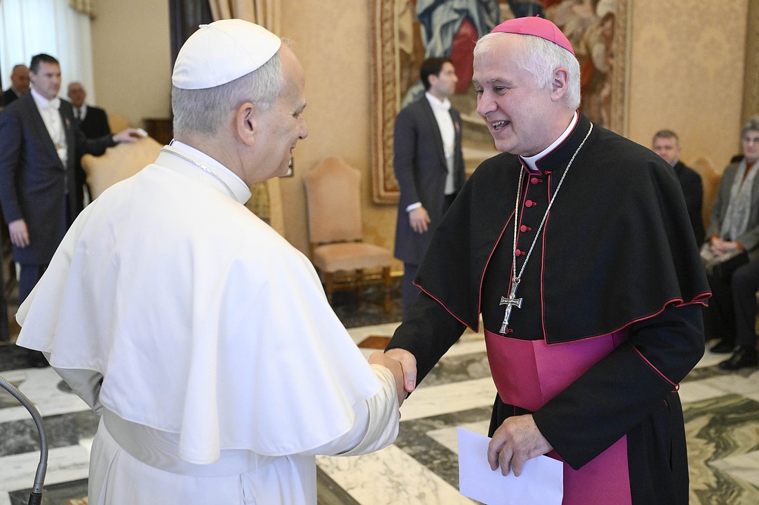 Pope Leo XIV shakes hands with Bishop Claudio Giuliodori, general ecclesiastical assistant of the University of the Sacred Heart in Milan, Italy, during an audience at the Vatican Dec. 5, 2025. The pope met with people taking part in a conference on AI that was organized by the Centesimus Annus Pro Pontifice Foundation and the Strategic Alliance of Catholic Research Universities. (CNS photo/Vatican Media).