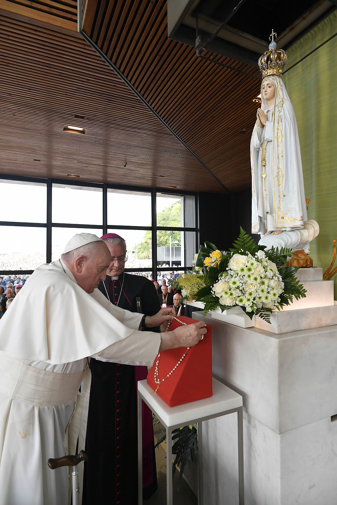 Pope Francis leaves a rosary before a statue of Mary in the Chapel of the Apparitions at the Shrine of Our Lady of Fatima in Fatima, Portugal, Aug. 5, 2023. (CNS photo/Vatican Media)