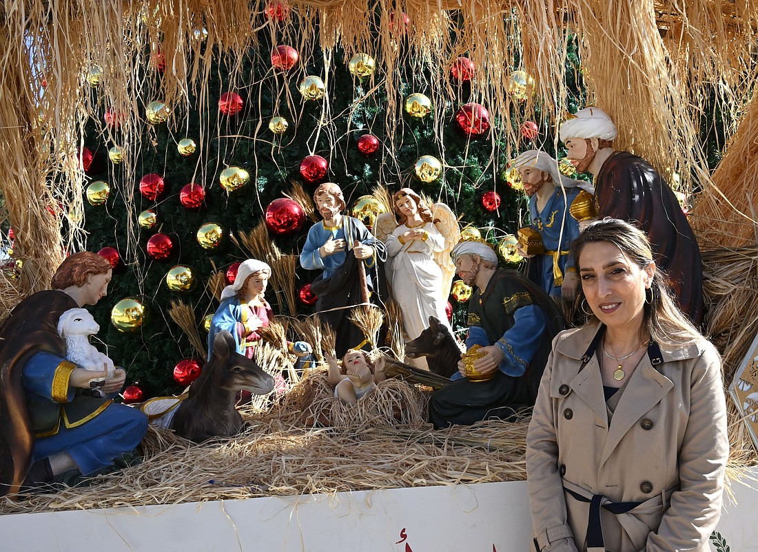 Palestinian Ranya Malki Bandak, director of the Bethlehem Peace Center, stands by a Nativity scene in Manager Square, outside the Church of Nativity in Bethlehem, West Bank, Dec. 8, 2025. The church is built on what is believed to be the site where Jesus was born. (OSV News photo/Debbie Hill)