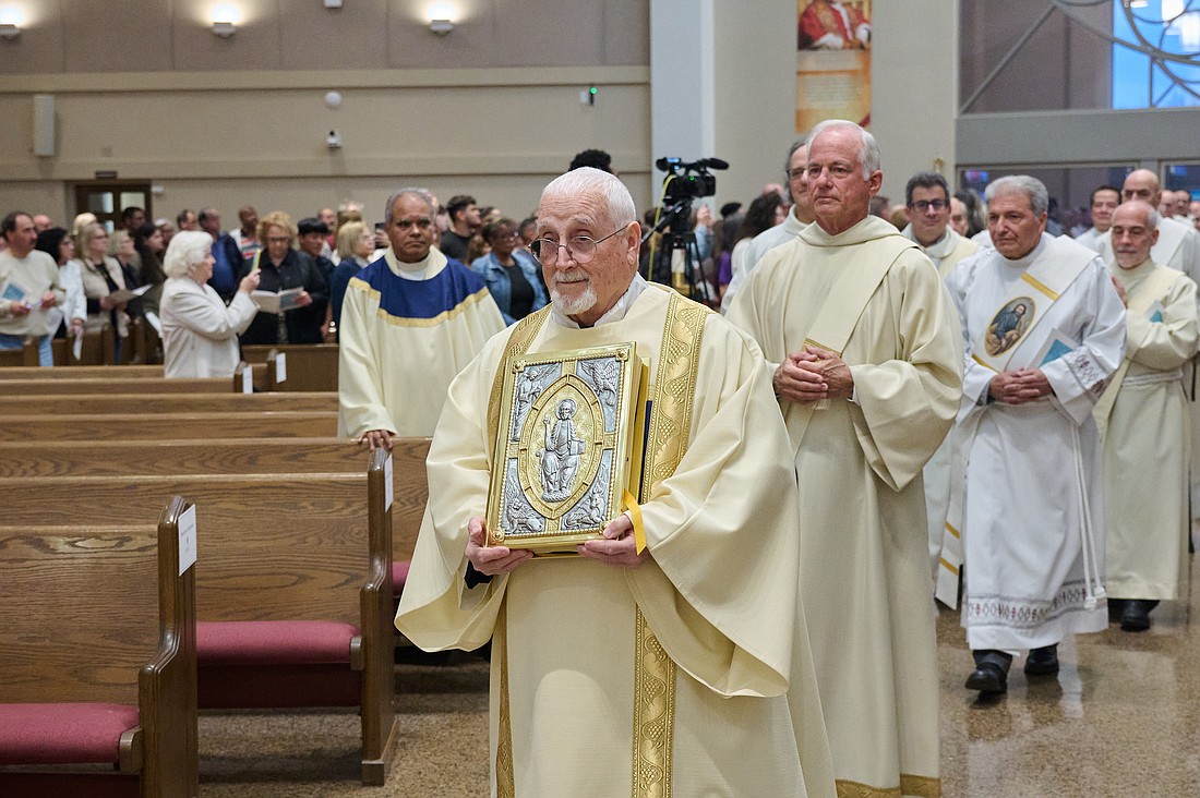 Rev. Brother Donald Ronning, C.O., carrying the Book of the Gospels, in front, served as the deacon for the 2025 Chrism Mass in St. Robert Bellarmine Co-Cathedral, Freehold. Brother Ronning will be ordained a priest for the Red Bank Oratory by Bishop David M. O’Connell, C.M., Dec. 20 at 10 a.m. in St. Anthony of Padua Church, Red Bank. Mike Ehrmann photo