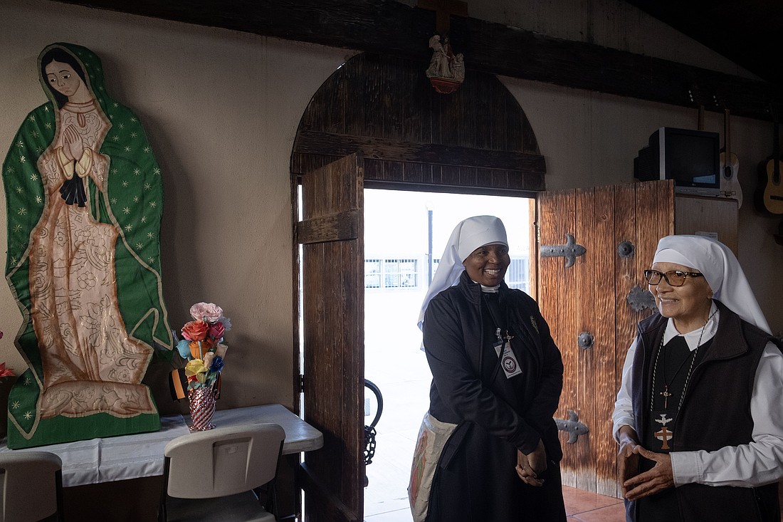 Sisters Ann Gertrude Djuidje, 56, from Cameroon, and Nelida Molina, 77, from Peru, smile as they enter the Catholic chapel at the La Mesa State Penitentiary before Mass was celebrated at the prison in Tijuana, Mexico, Dec. 1, 2025. The Mass was being celebrated on the birthday of Mother Antonia Brenner, founder of the Eudist Servants of the 11th Hour, which does ministry and social work in the prison, as well as work with cancer and HIV/AIDS patients and the poor. (OSV News photo/David Maung).
