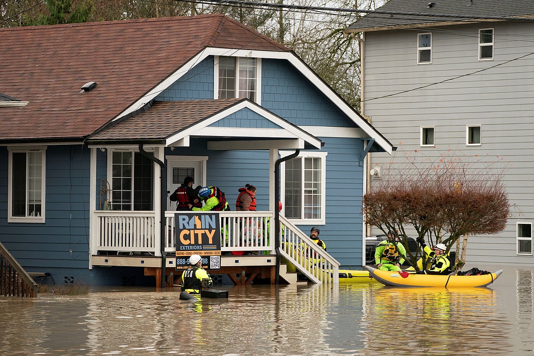 Rescue personnel evacuate Ivan Alvarez and Fabiola Alvarez, who were stranded in their home in an area flooded by the Snohomish River in Washington state Dec. 10, 2025, as an atmospheric river brings rain and flooding to the Pacific Northwest. Washington Gov. Bob Ferguson declared a statewide emergency Dec. 10, saying, “Lives will be at stake in the coming days.” He estimated that as many as 100,000 Washington residents may soon face evacuation orders.(OSV News photo/David Ryder, Reuters)