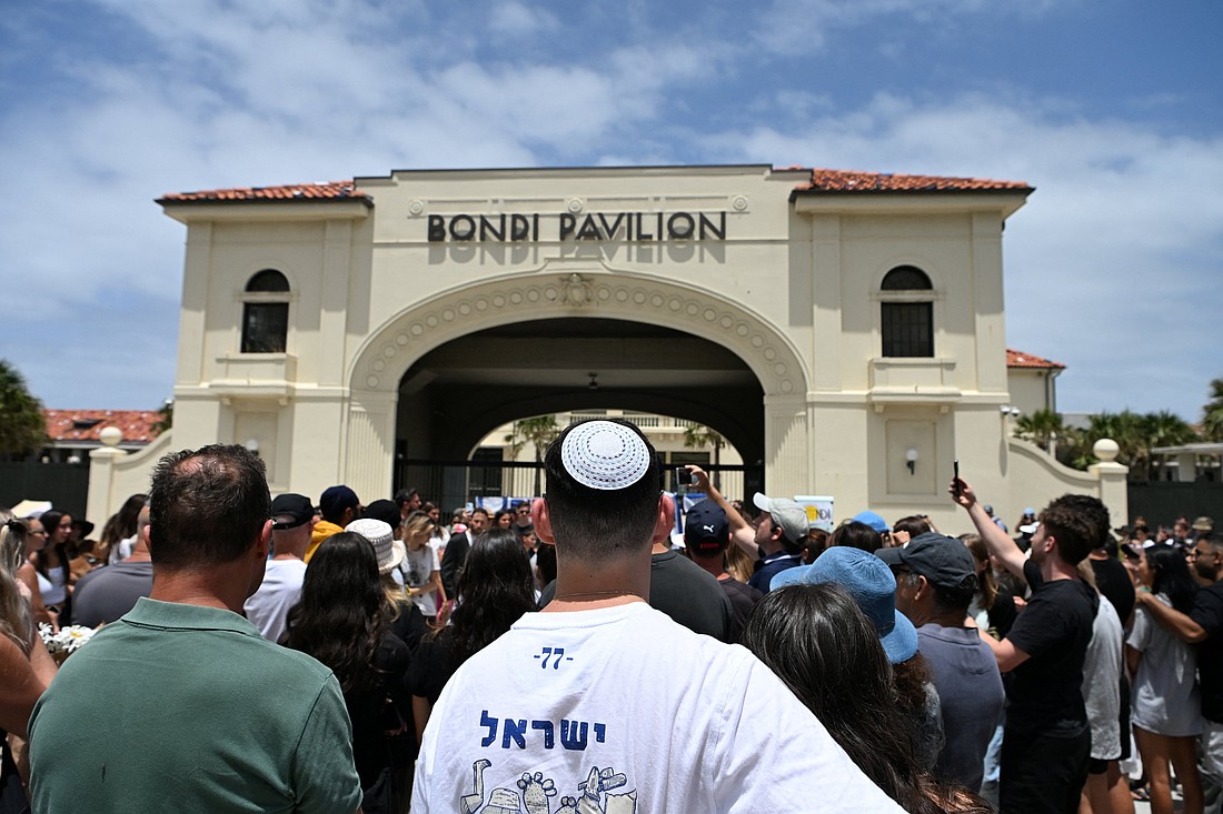 People gather in front of a flower tribute near Bondi Pavilion Dec. 15, 2025, a day after an anti-Jewish terror attack at Bondi Beach in Sydney. (OSV News photo/Flavio Brancaleone, Reuters).