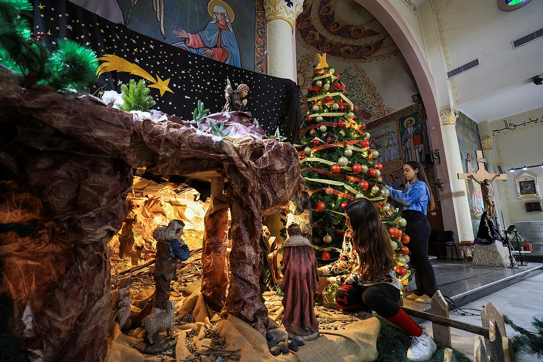Palestinian girls decorate a Christmas tree and Nativity inside Holy Family Church in Gaza City Dec. 9, 2025, as the community prepared for modest Christmas celebrations after two years of war. Throughout the month of December, Caritas Jerusalem launched the "Christmas of Hope," a campaign meant to address the "deep need to restore joy, dignity, and spiritual renewal to communities that have endured" the devastation of war. (OSV News photo/Dawoud Abu Alkas, Reuters)
