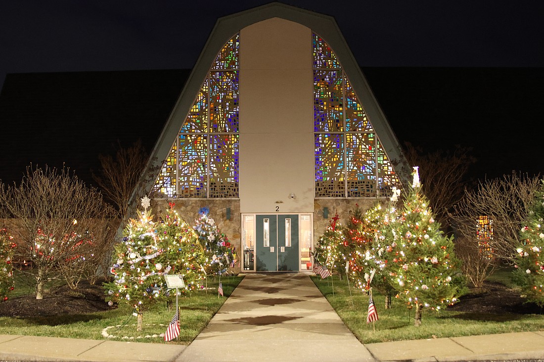 Christmas trees line an entrance to St. Mary of the Lakes Church, Medford. Parishioners were invited to decorate a tree in memory or honor of a loved one. The trees were lit in early December. Courtesy photo