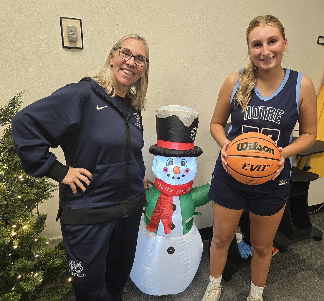 In a full circle saga, former Notre Dame High star basketball player Beth Fitzpatrick (left) was best friends with Lou Bucchere, another Irish star player, in both high school and college. And now Fitzpatrick is coaching Lou's daughter, Tori (right), as the NDHS snowman enjoys it all. Photo by Rich Fisher