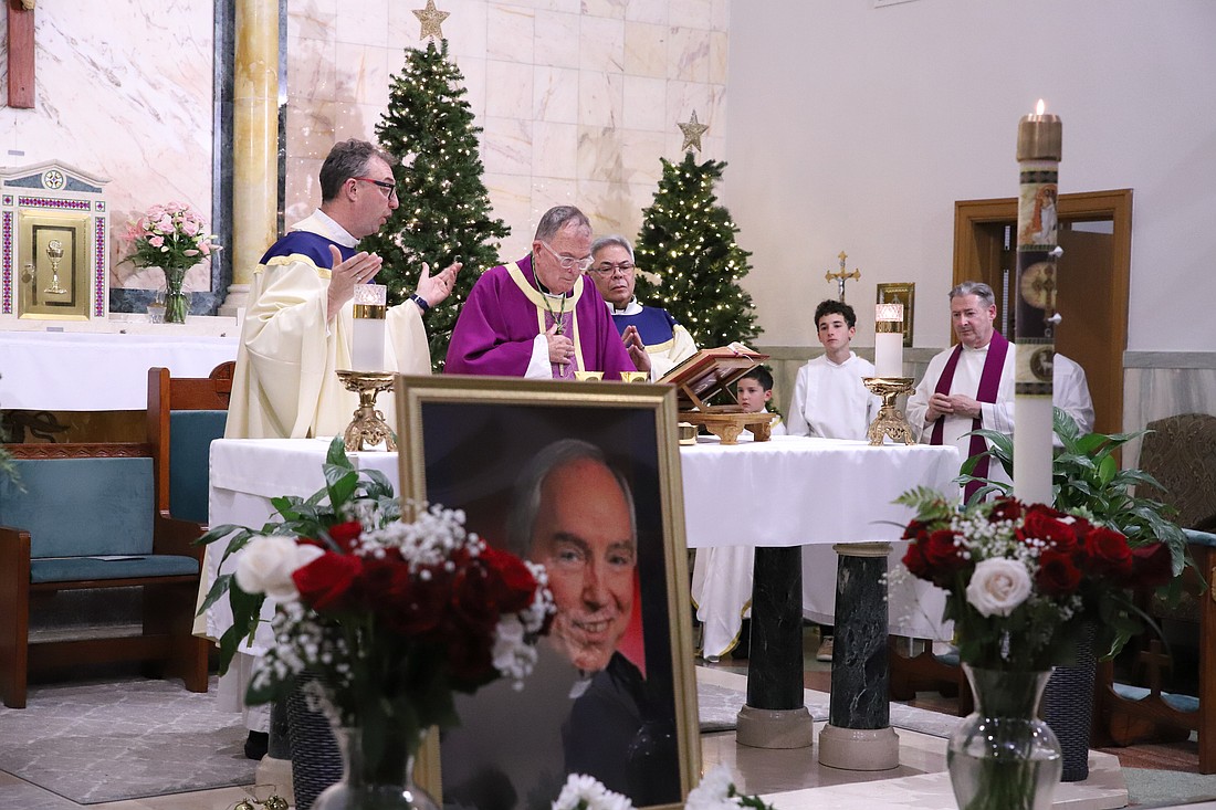 Bishop O'Connell stands at the altar of St. Mark Church, Sea Girt, where he celebrated a Memorial Mass for Msgr. Flynn Dec. 18. At left is Father Martin O'Reilly, who was homilist. At right is Divine Word Father Miguel Virella, pastor of St. Mark Parish. At far right is Father Damian McElroy, pastor of nearby St. Catharine-St. Margaret Parish, Spring Lake. John Batkowski photo