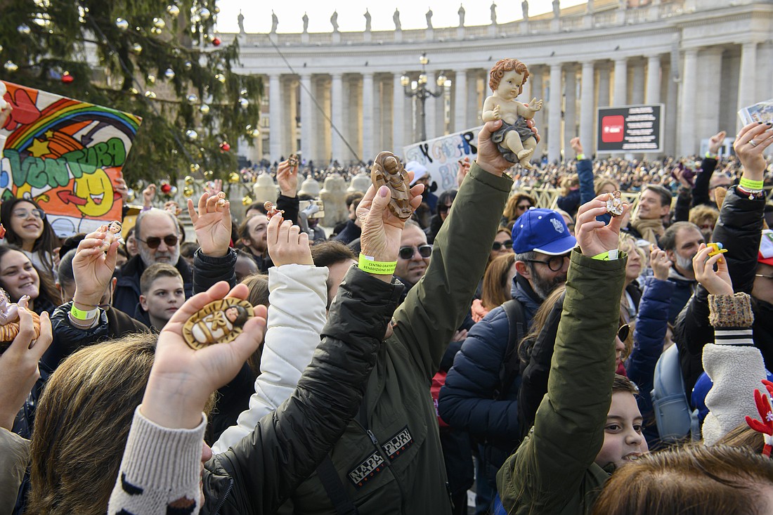 Children hold up the figurines of the Baby Jesus they will place in their Nativity scenes after they are blessed by Pope Leo XIV in St. Peter's Square at the Vatican Dec. 21, 2025. (CNS photo/Vatican Media)