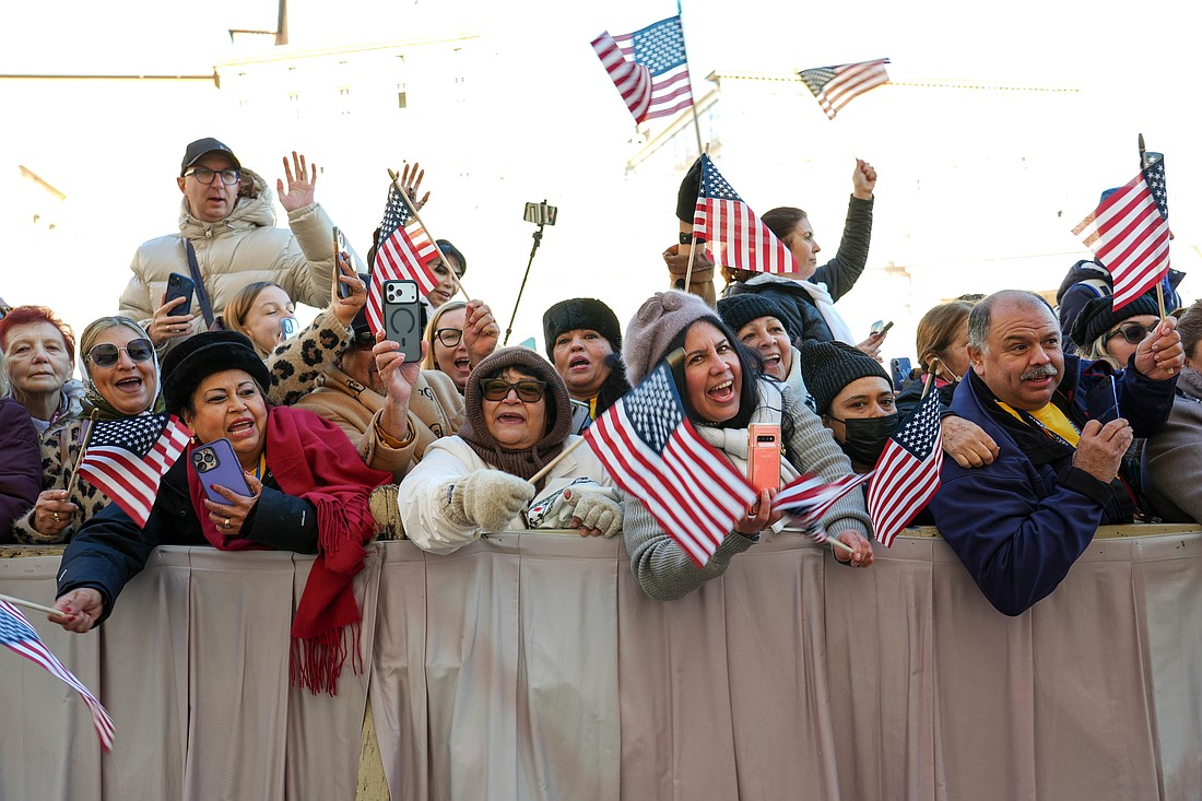 Visitors from California wave U.S. flags as they cheer for Pope Leo XIV in St. Peter’s Square at the Vatican before his weekly general audience Dec. 10, 2025. (CNS photo/Lola Gomez)