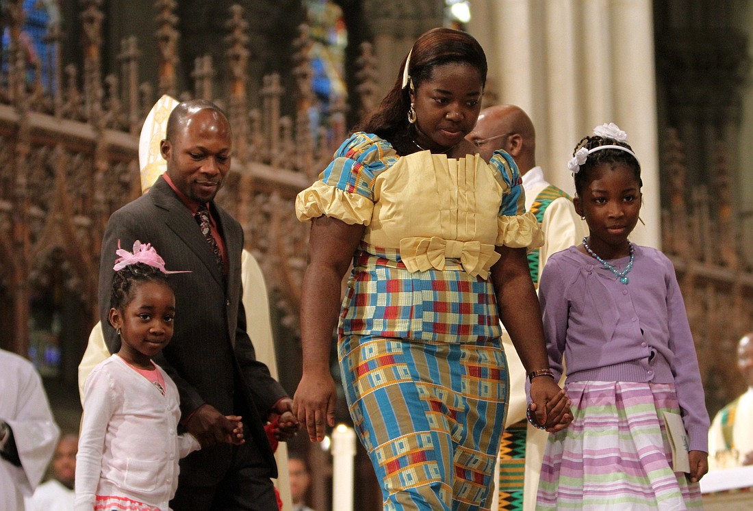 A file photo shows a family leaving the altar after presenting the gifts during  Mass at St. Patrick's Cathedral in New York. (OSV News photo/Gregory A. Shemitz)