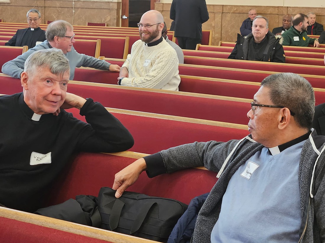 Father Vincent Euk, a retired priest, left, and Father Vicente Magdaraog, parochial vicar of Visitation Parish, Brick, take time to catch up during the Advent Spirituality Day for priests of the Diocese. Mary Stadnyk photos