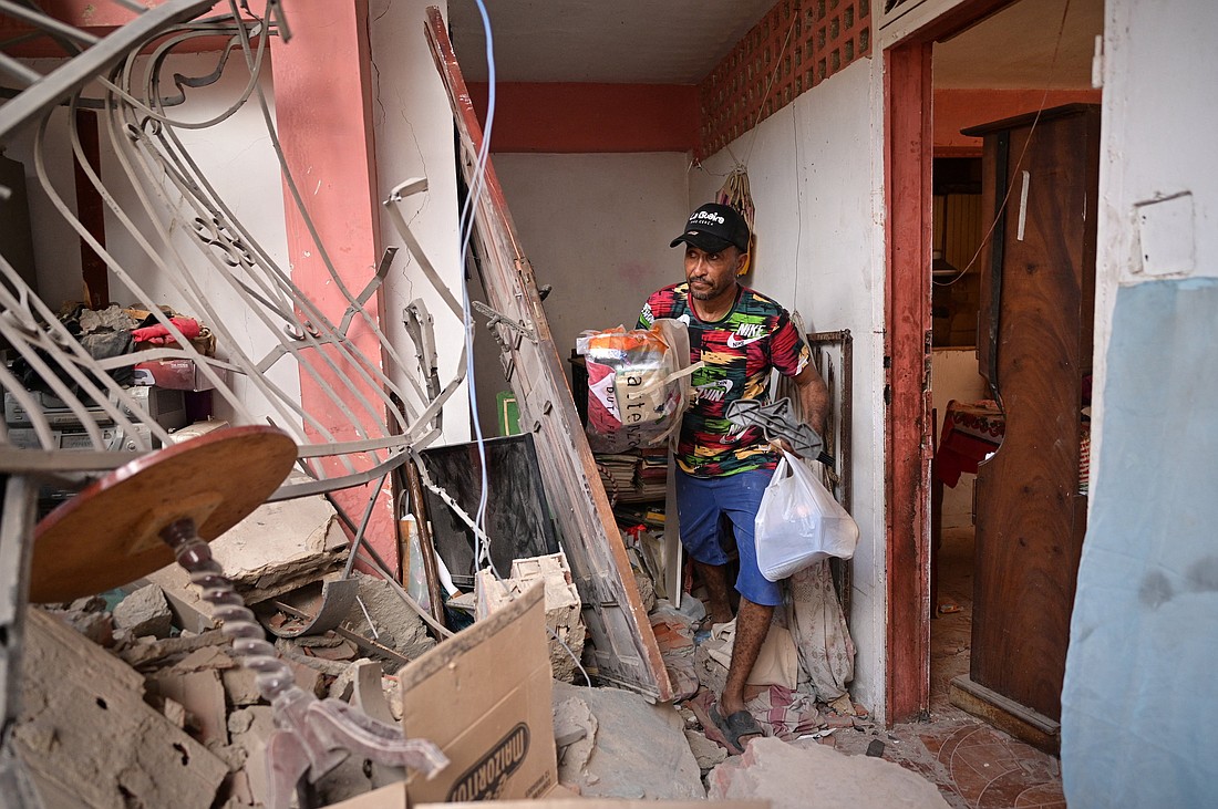 Jonathan Mayora collects items from his damaged family home in Catia La Mar, Venezuela, Jan. 4, 2026, after the U.S. launched a strike on Venezuela, capturing its President Nicolas Maduro and his wife Cilia Flores. (OSV News photo/Gaby Oraa, Reuters)