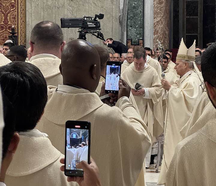 Father Jean Felicien, captures a cell phone photo of Pope Leo XIV during the Jan. 6 Mass for the Solemnity of the Epiphany in St. Peter's Basilica at the Vatican. Father Felicien, Bishop O'Connell and Msgr. Gervasio concelebrated the Epiphany Mass.