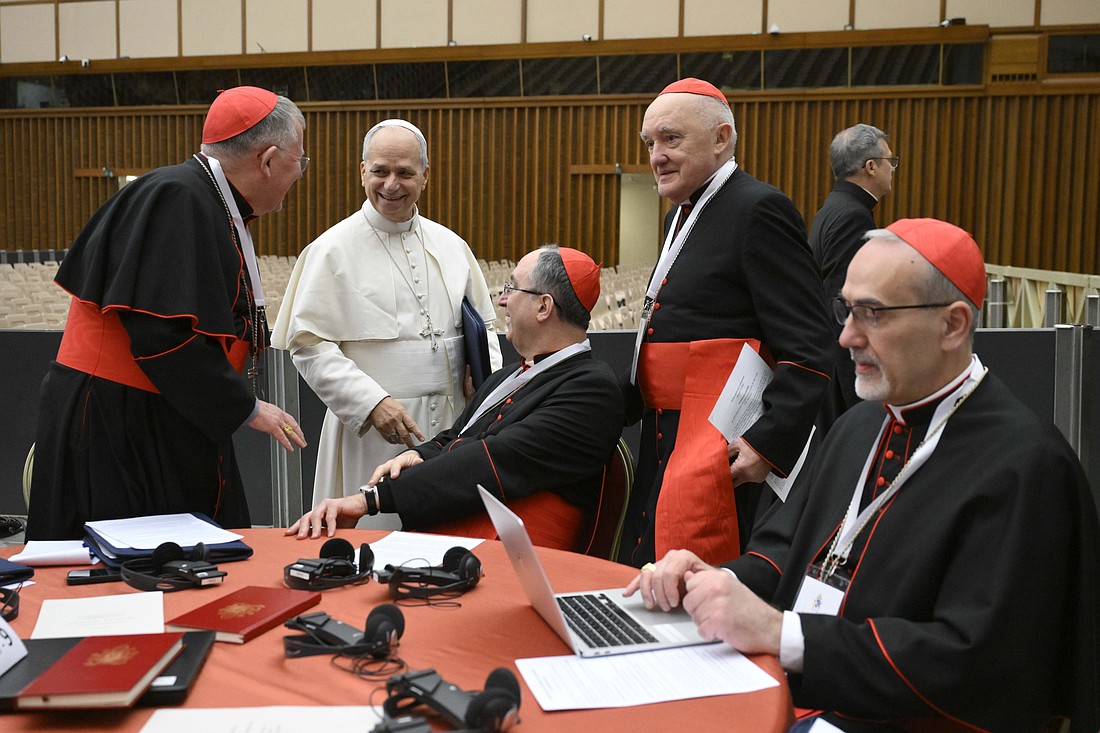 Pope Leo XIV shares a light moment with cardinals during a break as he holds a consistory with cardinals from around the world at the Vatican Jan. 8, 2026. In the foreground is Cardinal Pierbattista Pizzaballa, the Latin patriarch of Jerusalem. (OSV News photo/Simone Risoluti, Vatican Media)