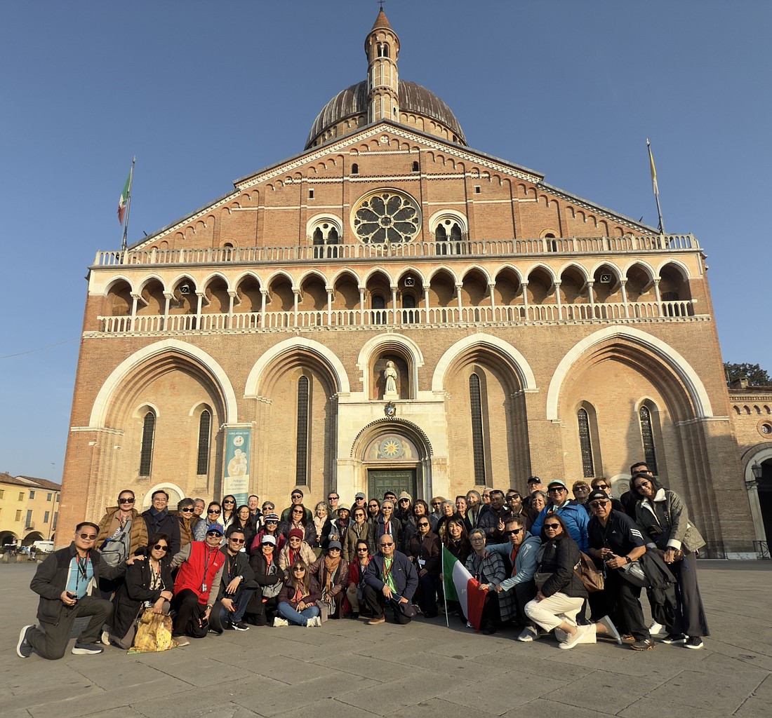Father Oscar Sumanga, pastor; Father Arian Wharff, parochial vicar; and Deacon Joseph Sbarra stand with fellow pilgrims – including parishioners and guests – in front of the Basilica of St. Anthony in Padua during a pilgrimage to Italy in November. Courtesy photo