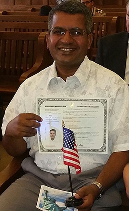 'One Among Them' -- Father Johnson takes Oath of Allegiance, becomes American citizen  